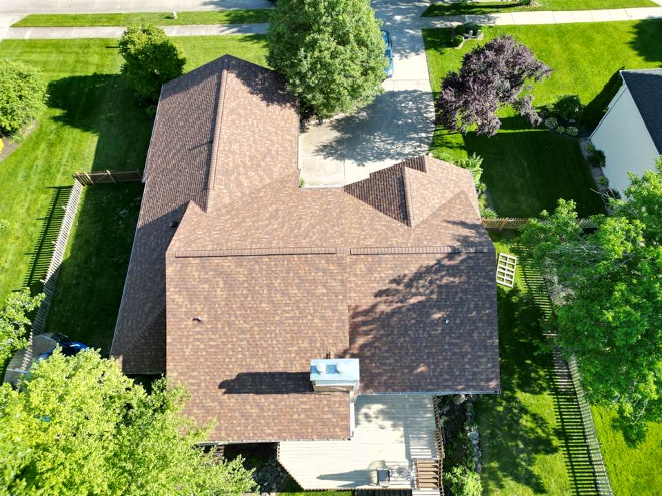 Aerial view of a home with a newly installed Owens Corning Duration shingle roof by Affordable Roofing after a two-layer tear-off