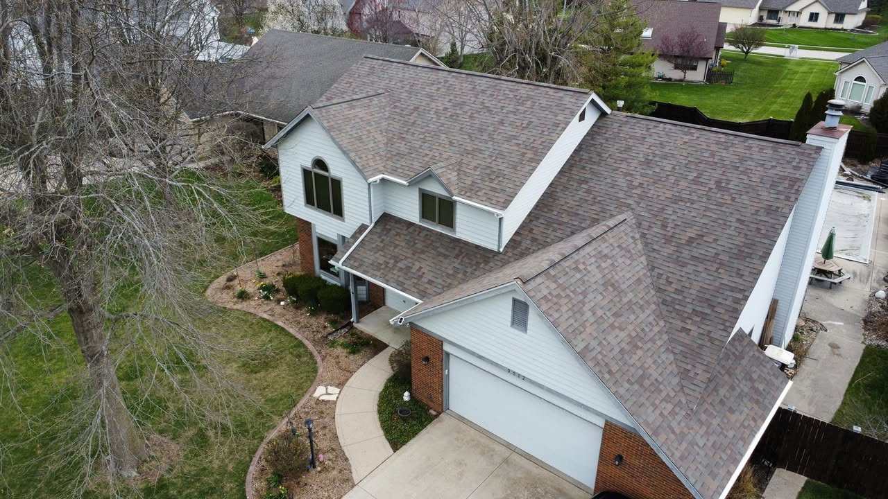 Aerial view of a home with a newly installed Owens Corning Duration shingle roof, seamless gutters, downspouts and gutter guards by Affordable Roofing