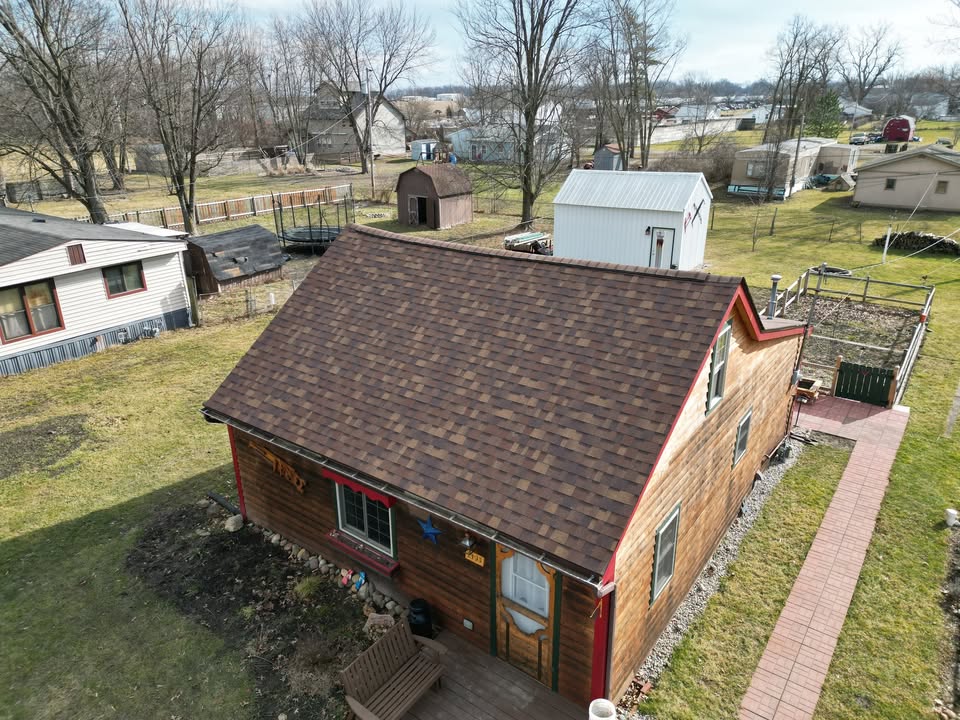 Aerial view of a home with a newly installed Owens Corning Duration shingle roof by Affordable Roofing, posted in February