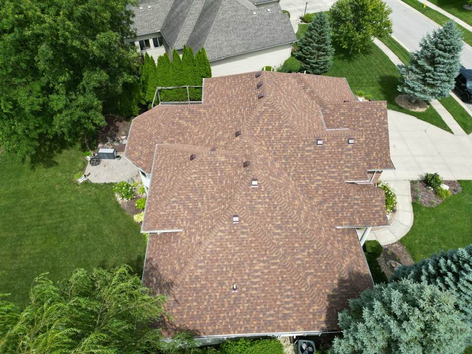 Aerial view of a large home with a newly installed Owens Corning Duration shingle roof by Affordable Roofing, installed in one day