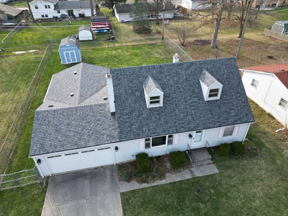 Aerial view of a home with a newly installed Owens Corning Duration shingle roof by Affordable Roofing, posted in March