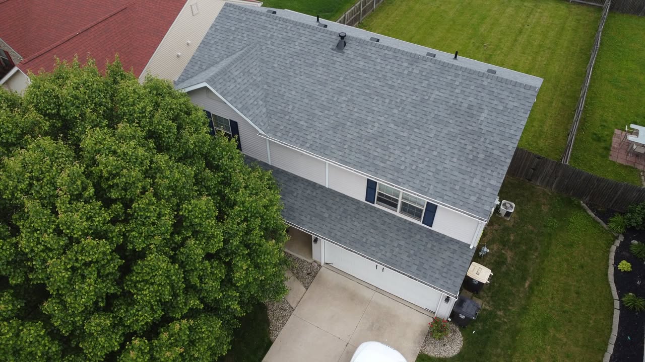 Aerial view of a two-story home with a newly installed Owens Corning Oakridge Estate Gray shingle roof by Affordable Roofing