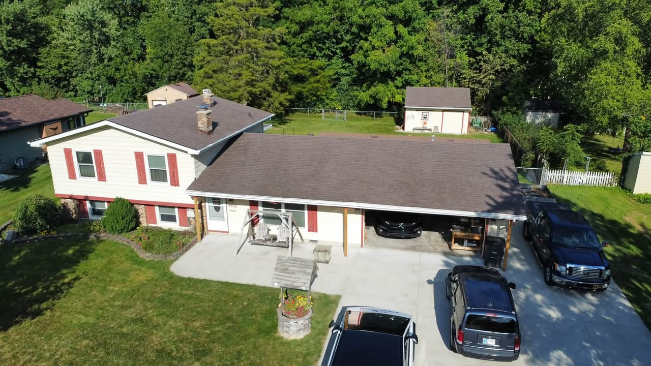 Aerial view of a home in Fort Wayne, IN with a newly installed Owens Corning Oakridge Teak shingle roof by Affordable Roofing