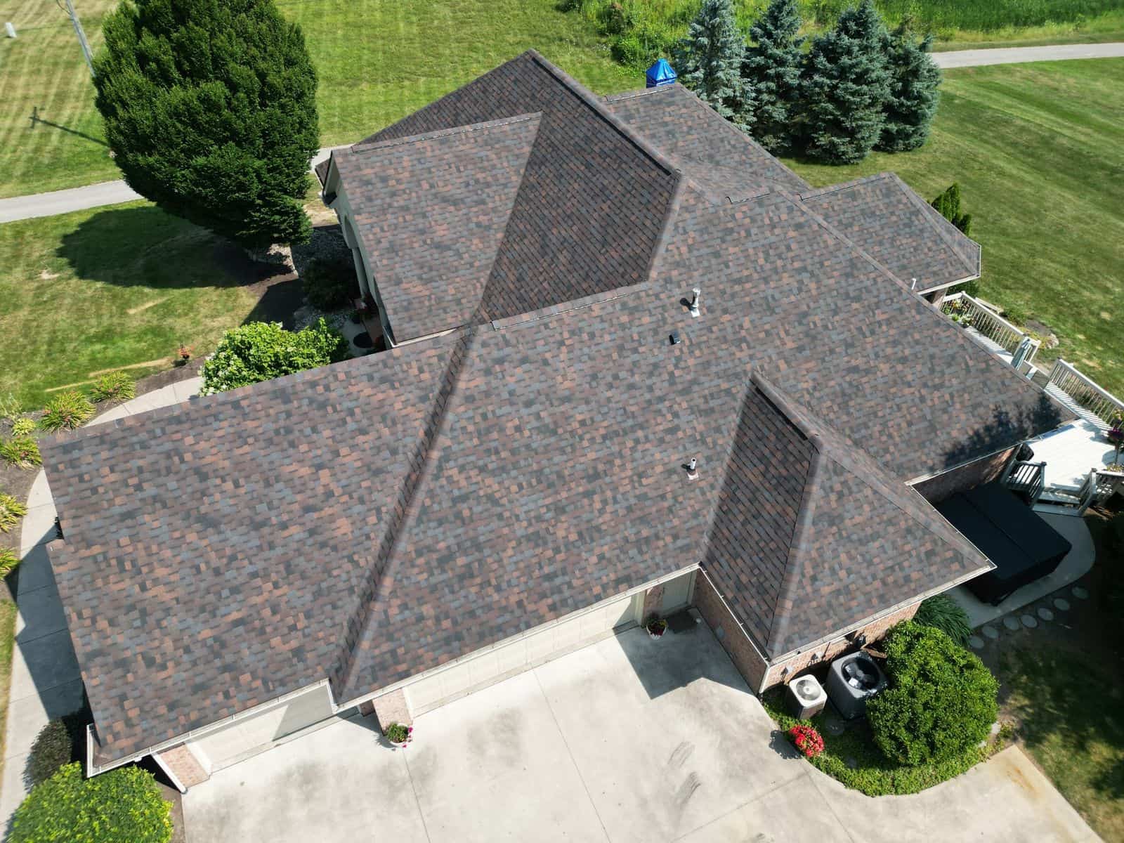 Brown architectural shingle hip roof replaced by Affordable Roofing in Fort Wayne